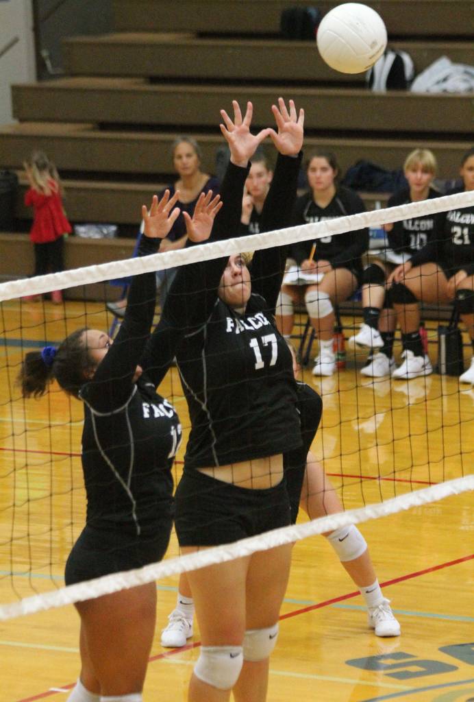 Maya Tschetter, left, and Morgan Batchelor rise to block a Sultan hit.(Photo by Jim Waller/South Whidbey Record)