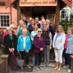 The members of the South Whidbey Garden Club pose for a photo on Annette Barcas stairs and deck a our tour of The Hummingbird Hill Garden in Greenbank. Photo submitted