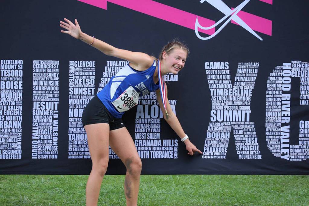 Kaia Swegler Richmond points out South Whidbey (spelling incorrectly) on the back drop of the podium.(Photo by Matt Simms)