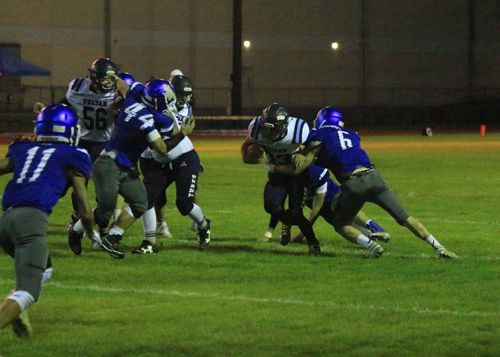 Dexter Jokinen (6) helps bring down a Sultan runner as Alex Black (11) and Tasman Dussault (44) close in.(Photo by Jim Waller/South Whidbey Record)
