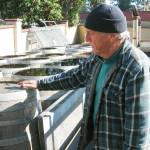 At the production facility of Britts Pickles in Clinton, owner Britt Eustis looks over the remaining inventory of oak barrels. The barrels, previously used for pickle-making, will be sold as the business closes. Photo by Dave Felice