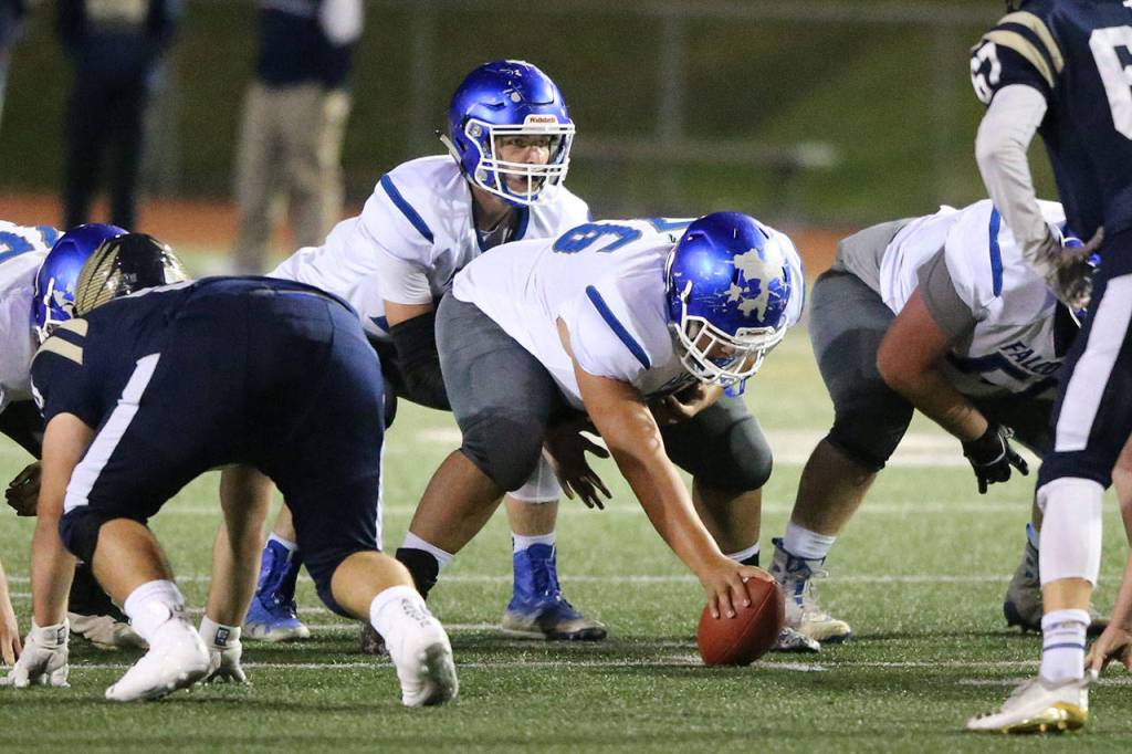Zain Balora gets ready to snap the ball to quarterback Kole Nelson.(Photo by John Fisken)