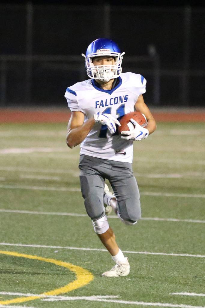 Alex Black picks up some yardage for the Falcons.(Photo by John Fisken)