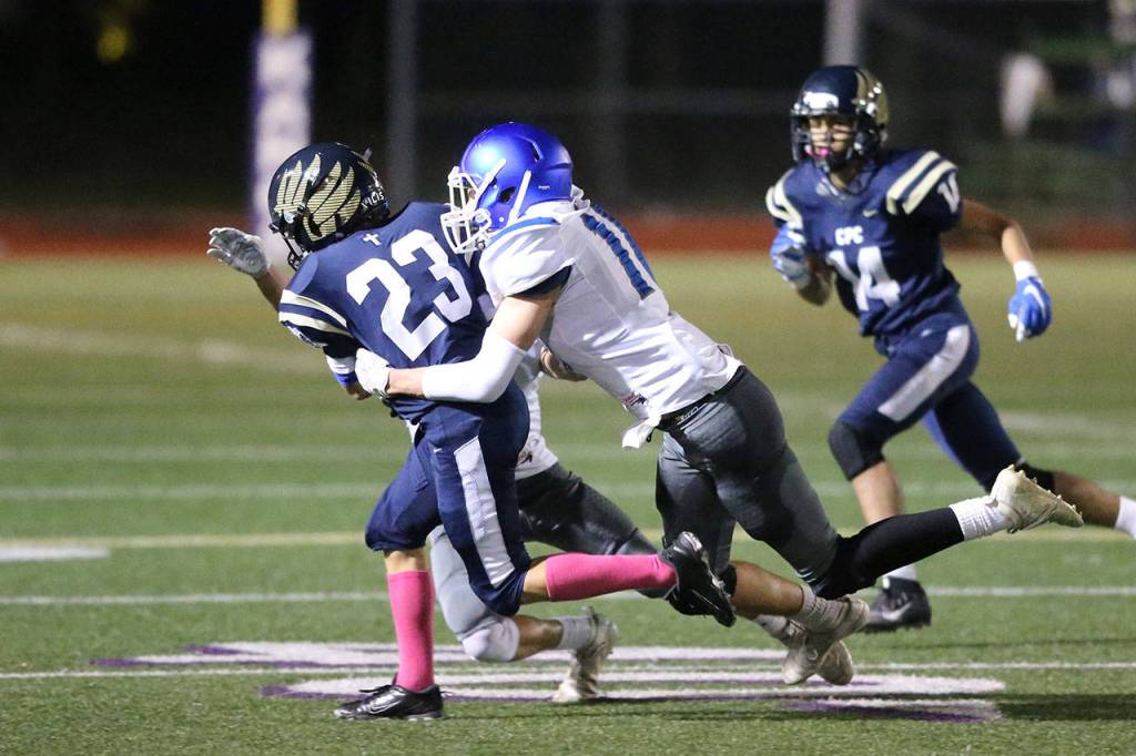 The Falcons Aidyn Frederick brings down Cedar Park Christians Isaac Ferguson.(Photo by John Fisken)