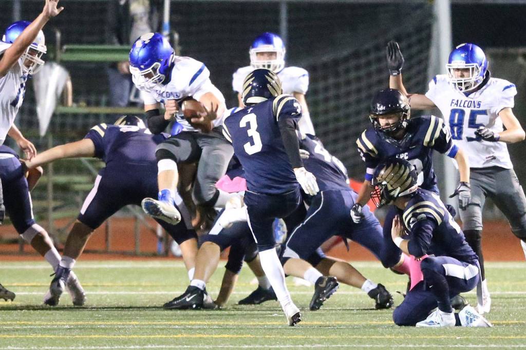 Kole Nelson blocks the point-after kick attempted by Cedar Park Christians Ethan Thomas.(Photo by John Fisken)