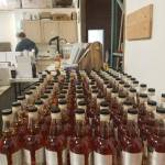 Craft whiskeys at Mutiny Bay Distillery are bottled and labeled by hand. Photo courtesy of Mutiny Bay.