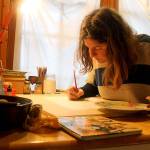 Photo by Kira Erickson / South Whidbey Record                                Anna Cosper paints a design for a commissioned holiday card in her studio.