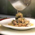 Chef Damien Cortez plates manila clams with wild board sausage, lemon, garlic, shallots, cooked in Rainier beer.