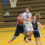 Kole Nelson is fouled on the way to the hoop. (Photo by Jim Waller/Sound Whidbey Record)