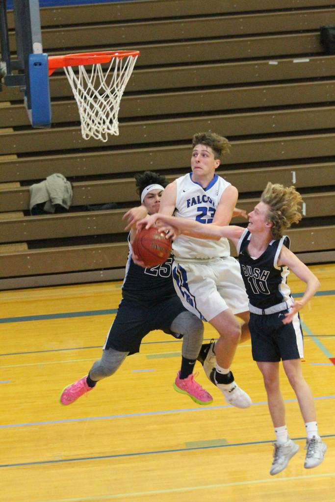 Kole Nelson is fouled on the way to the hoop. (Photo by Jim Waller/Sound Whidbey Record)
