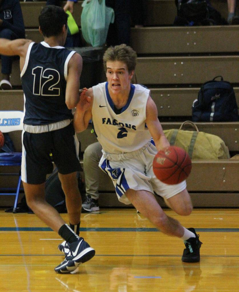 Nick Young flies by Bushs Deven Goel (12).(Photo by Jim Waller/Sound Whidbey Record)