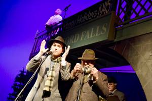 Clarence the angel, played by Jim Scullin, looks to the heavens for advice on how to help George Bailey (Gabe Harshman, left) and Uncle Billy (James Hinkley) in a scene from Its a Wonderful Life. Photo by Patricia Guthrie