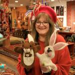 Photos by Kira Erickson / Whidbey News Group                                Employee Deborah Eimers models a felt hat and two puppets from Music For the Eyes, a Langley store offering cultural pieces from around the world.
