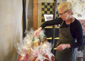 Photos by Patricia Guthrie                                Whidbey WaxWorks artisan and owner Prescilla Lowry sorts through her handmade candles.