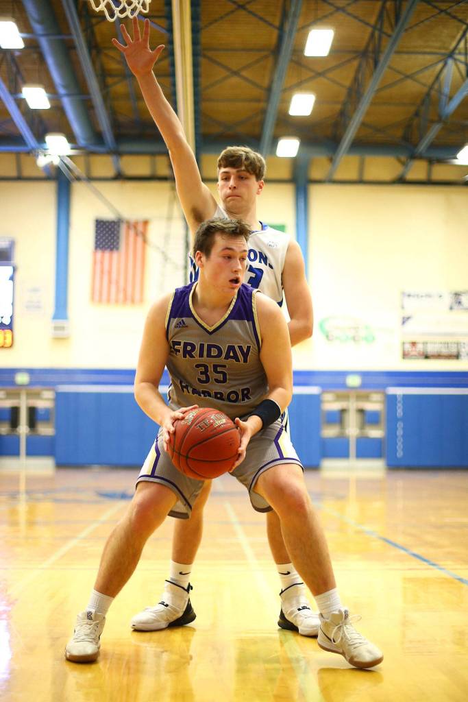 Kole Nelson defends Friday Harbors Gavin Mason.(Photo by John Fisken)
