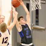 Carson Wrightson fights through an Anacortes foul.(Photo by John Fisken)