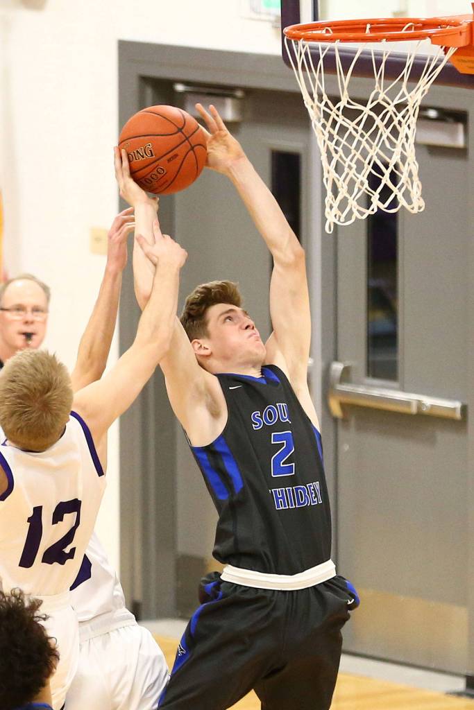 Carson Wrightson fights through an Anacortes foul.(Photo by John Fisken)