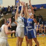 Madi Knauer (5) and Isabelle Wood leap for a rebound.(Photo by Jim Waller/South Whidbey Record)
