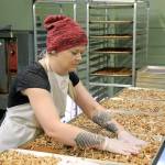 Photo by Kira Erickson/South Whidbey Record                                Kitchen Manager Hannah Hunsberger spreads the granola onto baking sheets and prepares it for baking Jan. 9.