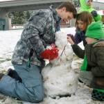 Fourth grade teacher James Nelson builds a snowperson with his students at South Whidbey Elementary School.