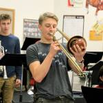 Junior Cooper Ullmannn plays a trombone solo during practice.