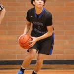 Jacob Ng prepares to lead the fast break with a long pass.(Photo by John Fisken)