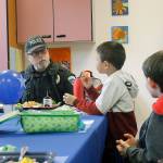 Photo by Kira Erickson/Whidbey News Group                                Chief of Police Don Lauer answers questions from first grader Ryu Peng and second grader Logan Caravan on Thursday.