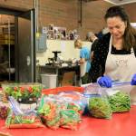 Photo by Kira Erickson/Whidbey News Group                                First-time WIN volunteer Kate ODonnell helps bag fresh veggies on Jan. 29.