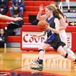 Liz Haines, center, splits the defense of Coupevilles Scout Smith, left, and Maddie Georges. (Photo by John Fisken)