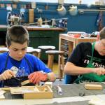 Photo by Kira Erickson/Whidbey News Group                                Seventh graders Zachary Craven and Sean Walker practice whittling a block of wood.
