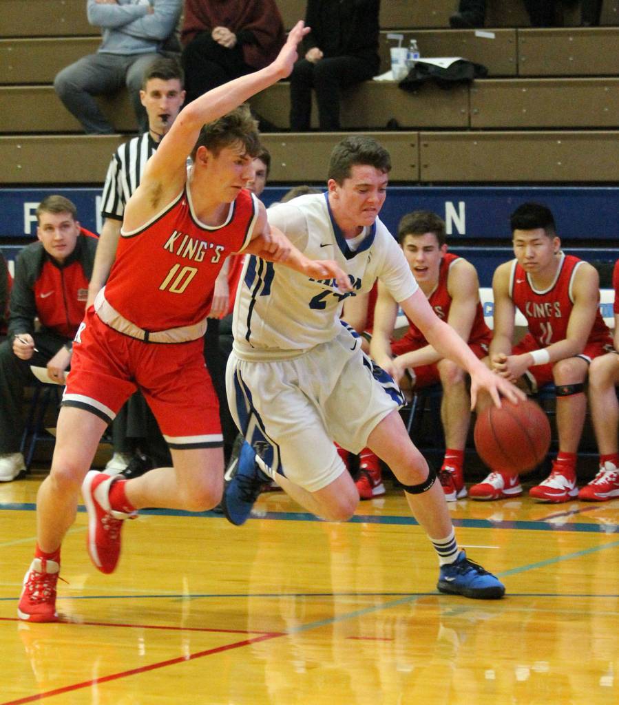 Sterling Patton tries to slip by the defense of Kings Jordan Hansen.(Photo by Jim Waller/South Whidbey Record)