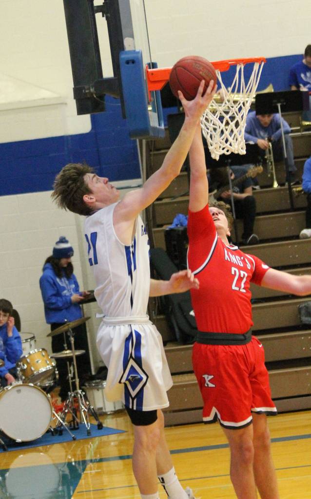 Carson Wrightson, left, shoots a reverse lay-in over Kings Tyler Linhardt.(Photo by Jim Waller/South Whidbey Record)