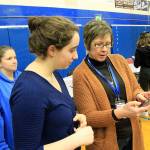 Photos by Kira Erickson/Whidbey News Group                                Volunteer Claire Commons helps junior Katherine Zundel make a credit payment.