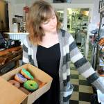 (Photos by Kira Erickson/Whidbey News Group)                                Employee Rashelle Scriven selects doughnuts for the cafes new blue glove delivery service.