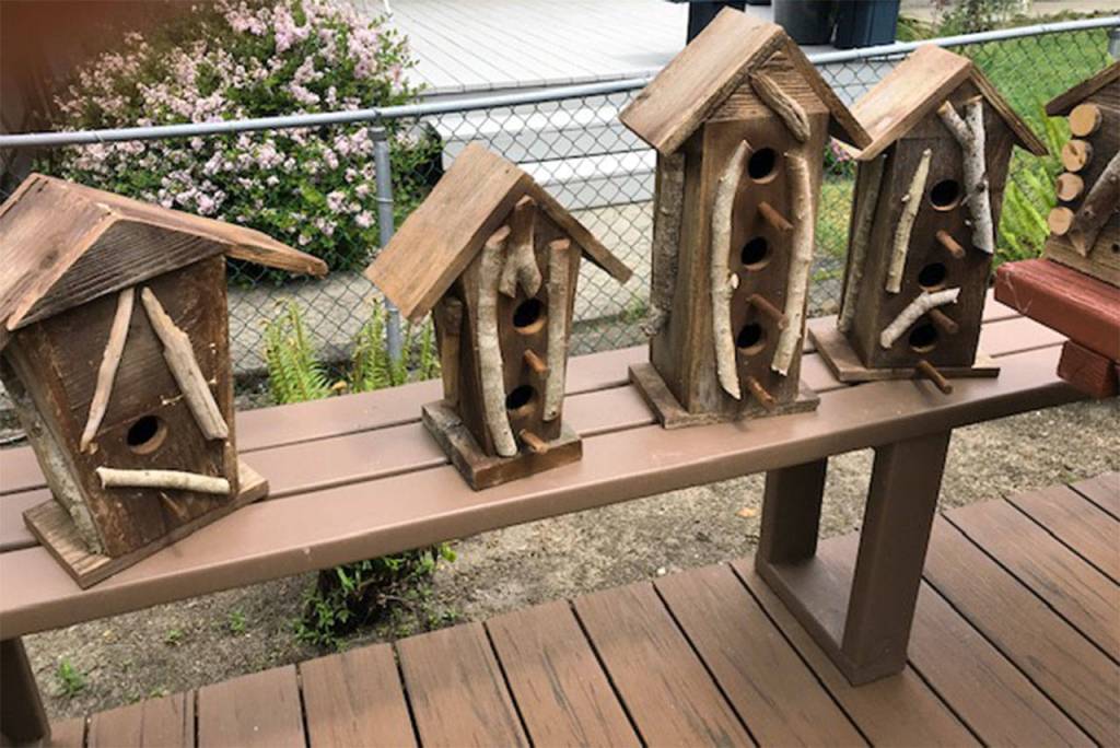 Lions member building birdhouses to help food bank