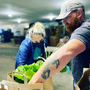 Photos provided                                Lauren Fletcher of Mutiny Bay Blues and Kyle Flack of Bells Farm pack weekly Food Hub orders. Flack said COVID-19 has helped people realize the importance of small-scale farming and shopping locally.