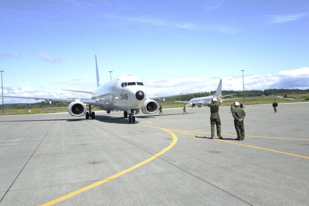 U.S. Navy photo by Mass Communicaton Specialist 2nd Class Jakoeb VanDahlen                                Sailors with VP-40 at Naval Air Station Whidbey Island place chocks under a P-8A Poseidon aircraft. VP-40 is the final active duty squadron to transition from the P-3C Orion aircraft to the P-8A Poseidon. VP-40 completed its transition 14 May 2020 on Naval Air Station Whidbey Island. The P-8 , a modified Boeing 737-800ERX, is an anti-submarine warfare, anti-surface warfare aircraft.