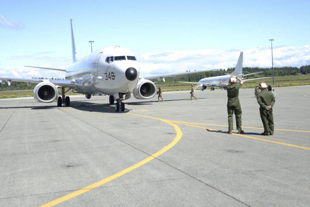 U.S. Navy photo by Mass Communicaton Specialist 2nd Class Jakoeb VanDahlen                                Sailors with VP-40 at Naval Air Station Whidbey Island place chocks under a P-8A Poseidon aircraft. VP-40 is the final active duty squadron to transition from the P-3C Orion aircraft to the P-8A Poseidon. VP-40 completed its transition 14 May 2020 on Naval Air Station Whidbey Island. The P-8 , a modified Boeing 737-800ERX, is an anti-submarine warfare, anti-surface warfare aircraft.