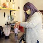 Photo by Kira Erickson/Whidbey News-Times                                Veronica Anguiano, who owns the Beary Scoop in Freeland with her husband, Mario Saenz, prepares a taro bubble tea, a blended Taiwanese sweet drink. The shop, which first opened in March, and reopened June 23, offers a combination of frozen yogurt and bubble tea.