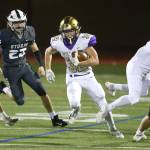 Oak Harbors Jake Mitten runs ball with the help of a block from Landon Cantrell last fall. The WIAA announced this week that football will be played in the spring this school year. (Photo by John Fisken)