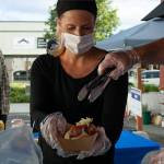 Julianne Blynn prepares a War Pig hot dog for customers during the Open Air Thursdays. Photo by Brandon Taylor
