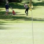 Stephanie Winship hits an approach shot at the Island Greens, which will close Sunday.(Photo by Jim Waller/Whidbey News-Times)