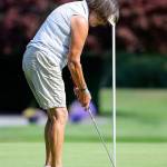 Pam Smith taps in a putt. (Photo by John Fisken)