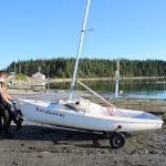 Henry Booth pulls his boat out of the water after practice. (Photo by John Fisken)