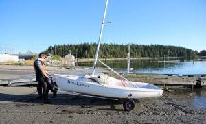 Henry Booth pulls his boat out of the water after practice. (Photo by John Fisken)