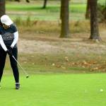 Molly McPherson watches a long putt roll to the cup in the Bennett Boyles Memorial Golf Tournament Saturday. (Photo by John Fisken)