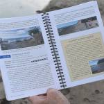 Jeanie McElwain opens the third edition of Getting to the Waters Edge to popular South Whidbey beach Double Bluff. More than 50 volunteers made the current book possible. Photo by Emily Gilbert/Whidbey News-Times