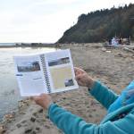 Jeanie McElwain holds the new edition of Getting to the Waters Edge, a book that includes information about beach accessibility, fishing spots, natural history, species identification and more, including all of the sea creatures that can be found at Double Bluff in South Whidbey. Photo by Emily Gilbert/Whidbey News-Times