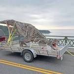 Photo by Scott PriceJoe Treats driftwood sculpture of a Tyrannosaurus rex rolls across Deception Pass Bridge Sunday. It was installed Monday morning at Price Sculpture Forest in Coupeville. The park is set to open Oct. 23.