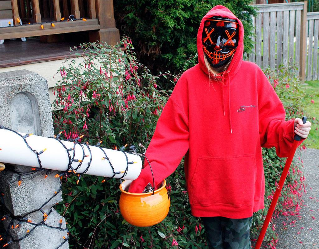Photo by Kira Erickson/Whidbey News GroupPiper Pontius, 11, demonstrates how the candy chute outside her grandparents house will work.